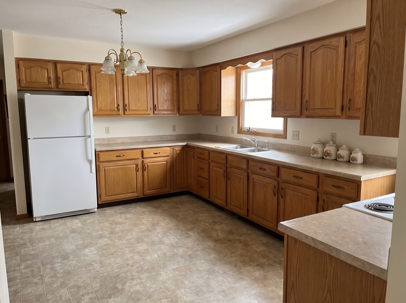 Same kitchen after AI furniture removal, counters and floor cleared